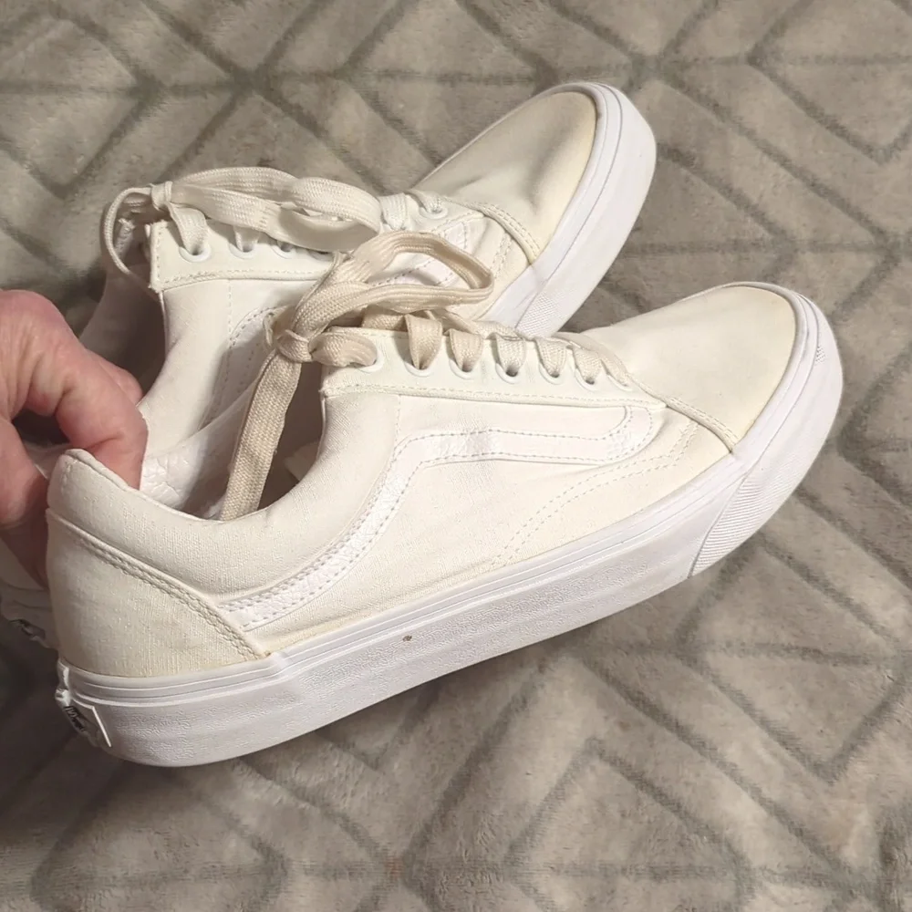 Vans Old Skool shoes in the True White or Monochrome‎ White colorway.